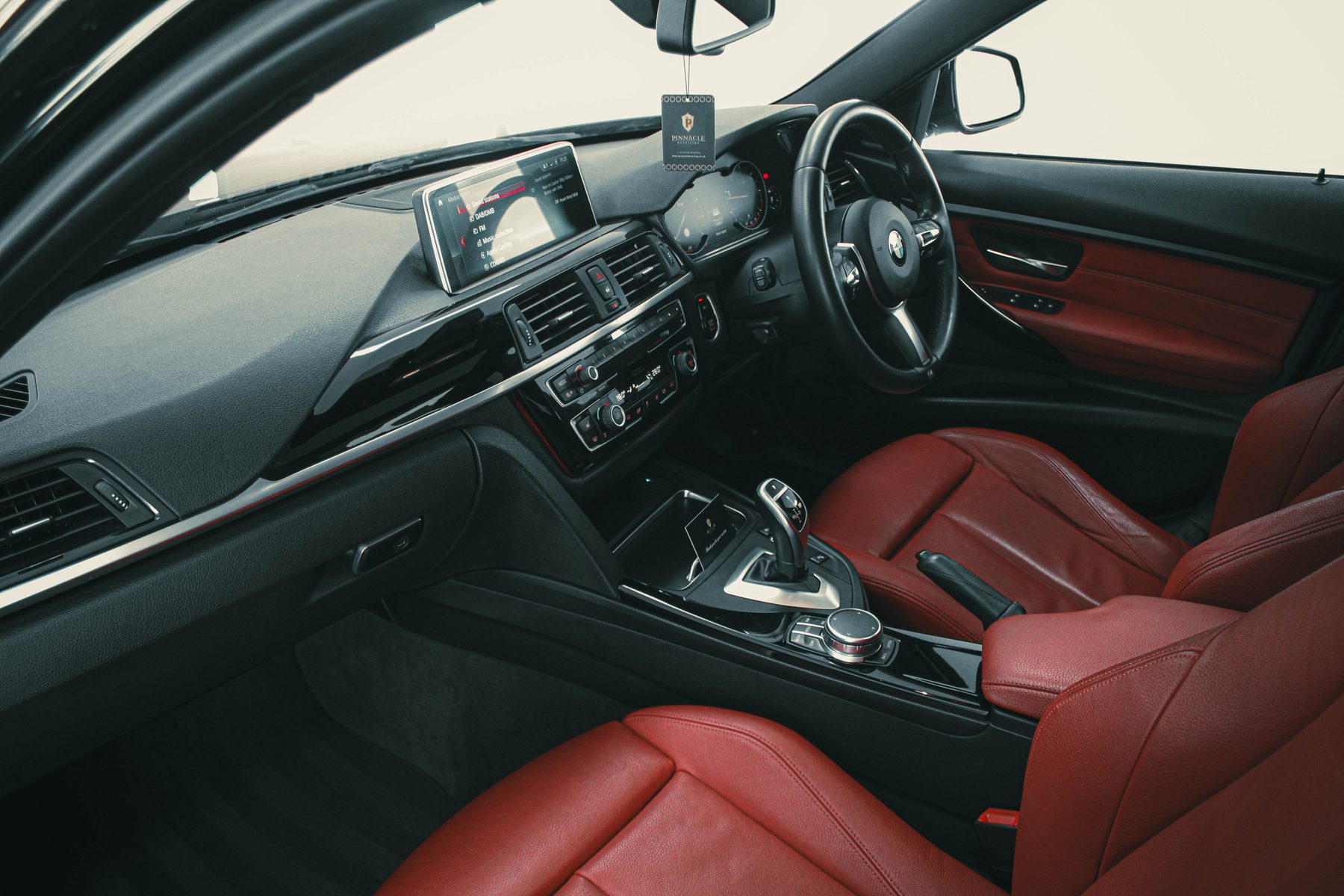 Detailer refining a dark paint finish